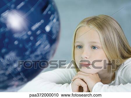 Girl looking at globe View Large Photo Image Stock Image - Girl looking at globe. Fotosearch