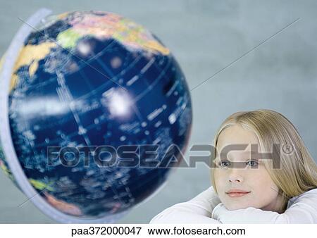 Girl looking at globe View Large Photo Image Stock Photo - Girl looking at globe. Fotosearch
