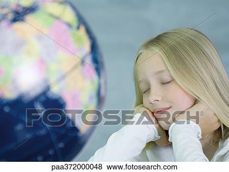 Girl next to globe, eyes closed View Large Photo Image Stock Photo - Girl next to globe, eyes closed. Fotosearch