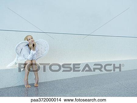 Picture - Girl wearing angel wings. Fotosearch