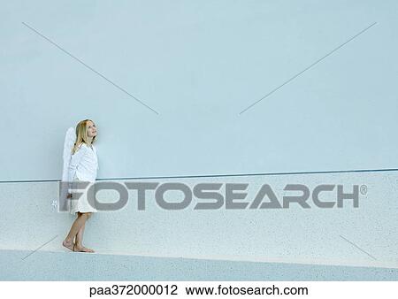 Girl wearing angel wings View Large Photo Image Stock Image - Girl wearing angel wings. Fotosearch