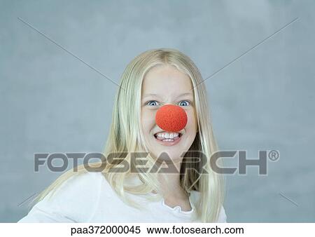 Girl wearing clown nose and making face View Large Photo Image Stock Photography - Girl wearing clown nose and making face. Fotosearch