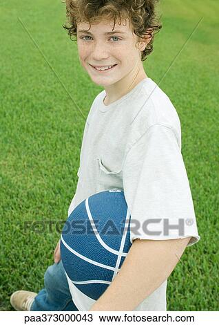 Boy holding basketball, portrait View Large Photo Image Stock Image - Boy holding basketball, portrait. Fotosearch