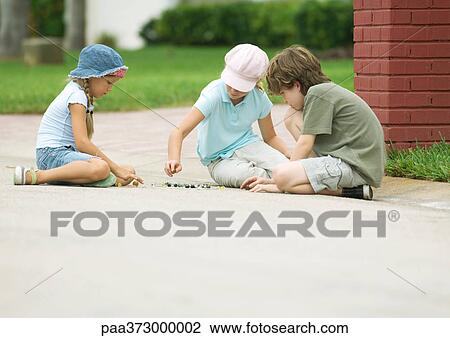 Children playing marbles in street View Large Photo Image Stock Image - Children playing marbles in street. Fotosearch