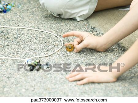 Children playing marbles on asphalt View Large Photo Image Stock Photo - Children playing marbles on asphalt. Fotosearch