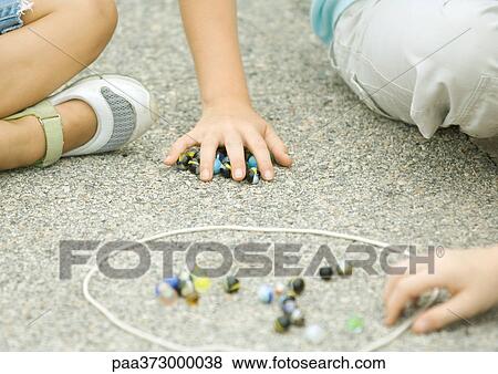 Children playing marbles on asphalt View Large Photo Image Stock Photo - Children playing marbles on asphalt. Fotosearch