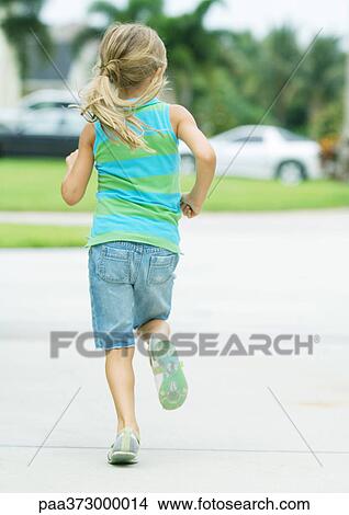Girl running in suburban neighborhood View Large Photo Image Picture - Girl running in suburban neighborhood. Fotosearch