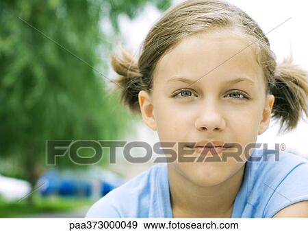 Stock Photo - Girl with pigtails, portrait. Fotosearch