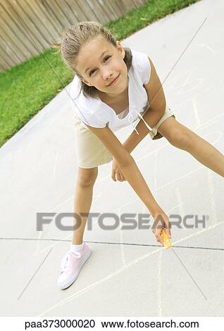 Girls drawing hopscotch squares on concrete View Large Photo Image Stock Image - Girls drawing hopscotch squares on concrete. Fotosearch
