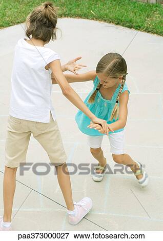 Stock Photo - Girls playing hopscotch. Fotosearch