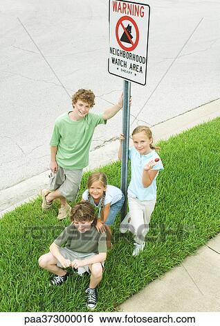 Suburban children grouped around neighborhood watch sign View Large Photo Image Stock Photograph - Suburban children grouped around neighborhood watch sign. Fotosearch