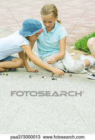 Suburban children playing marbles on asphalt View Large Photo Image Stock Image - Suburban children playing marbles on asphalt. Fotosearch