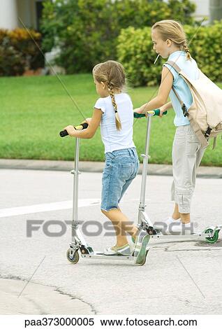 child riding scooter