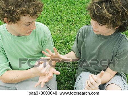Two boys playing rock paper scissors View Large Photo Image Stock Photo - Two boys playing rock paper scissors. Fotosearch