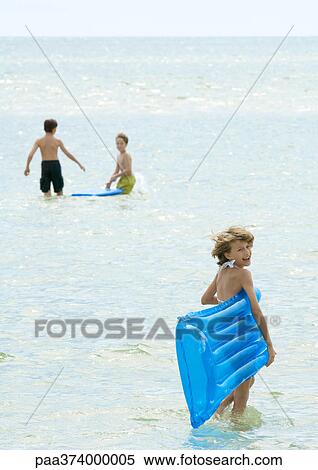 Children playing in water at beach View Large Photo Image Stock Photography - Children playing in water at beach. Fotosearch