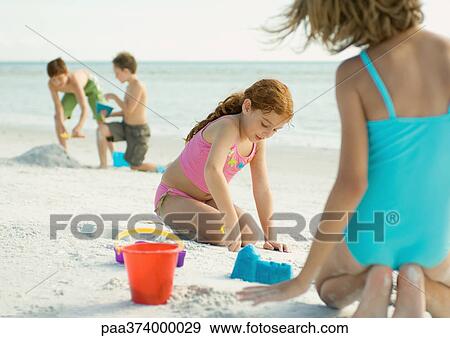 Stock Photo - Children playing on the beach. Fotosearch