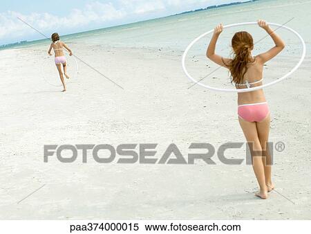 Stock Photography - Children playing on the beach. Fotosearch