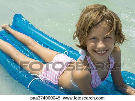 Girl lying on raft View Large Photo Image Stock Photography - Girl lying on raft. Fotosearch