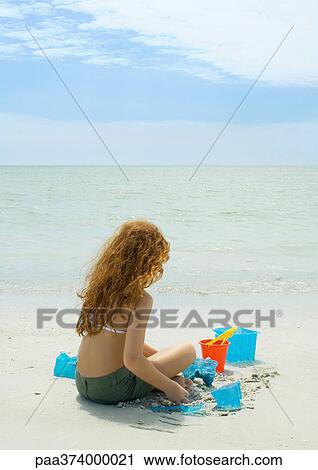 Girl playing on the beach View Large Photo Image Stock Image - Girl playing on the beach. Fotosearch