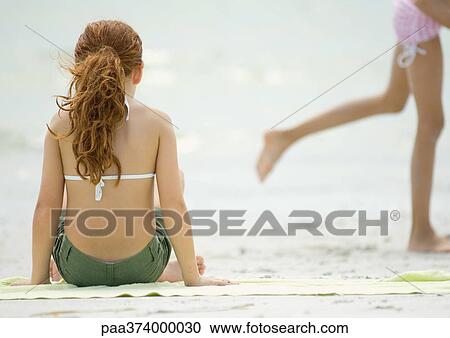 Girl sitting on beach View Large Photo Image Stock Image - Girl sitting on beach. Fotosearch