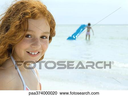 Girl smiling, ocean in background View Large Photo Image Stock Image - Girl smiling, ocean in background. Fotosearch