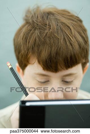 Picture - Boy doing homework. Fotosearch