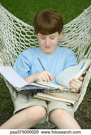 Boy sitting in hammock doing homework View Large Photo Image Stock Photo - Boy sitting in hammock doing homework. Fotosearch