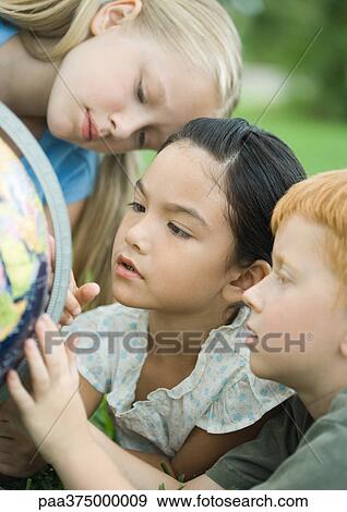 Children looking at globe View Large Photo Image Stock Photo - Children looking at globe. Fotosearch