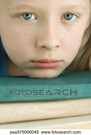 Girl resting chin on stack of books View Large Photo Image Stock Photo - Girl resting chin on stack of books. Fotosearch