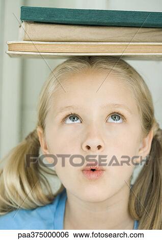 Girl with stack of books on head, making face View Large Photo Image Stock Photograph - Girl with stack of books on head, making face. Fotosearch