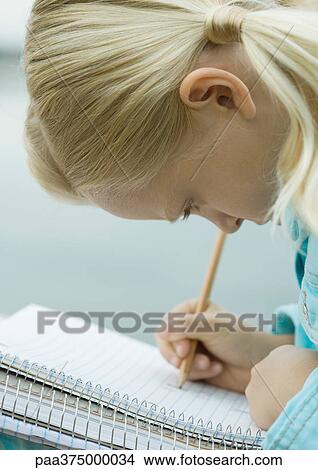 Girl writing in notebook View Large Photo Image Picture - Girl writing in notebook. Fotosearch