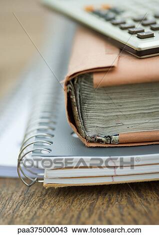 Stack of notebooks, books, and calculator View Large Photo Image Stock Image - Stack of notebooks, books, and calculator. Fotosearch