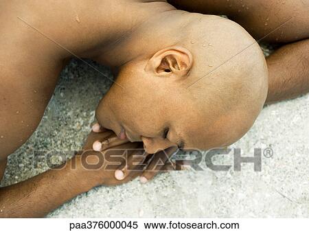 Man sleeping on sand View Large Photo Image Stock Photography - Man sleeping on sand. Fotosearch