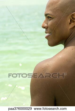 Man smiling, profile, sea in background View Large Photo Image Stock Photo - Man smiling, profile, sea in background. Fotosearch