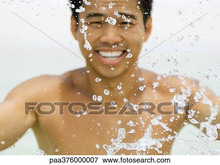 Man splashing in water View Large Photo Image Stock Photo - Man splashing in water. Fotosearch