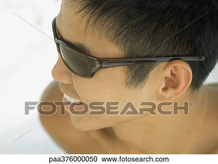 Stock Image - Man wearing sunglasses. Fotosearch