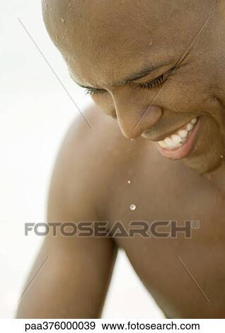 Stock Photo - Man with wet face, smiling. Fotosearch