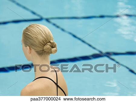 Picture - Woman facing pool, rear view. Fotosearch
