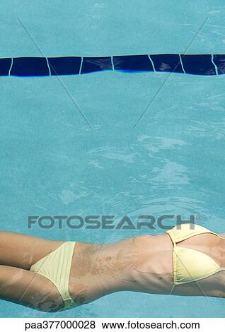 Woman floating in pool, view off mid-section View Large Photo Image Stock Photo - Woman floating in pool, view off mid-section. Fotosearch