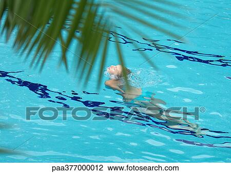 Woman lifting head out of water in pool View Large Photo Image Stock Image - Woman lifting head out of water in pool. Fotosearch