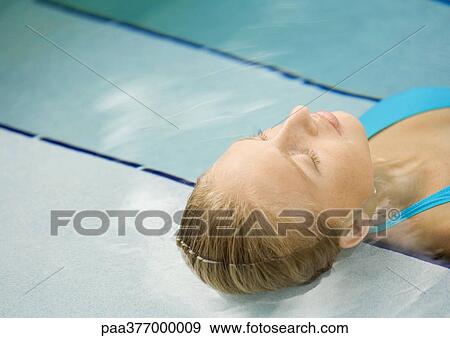 Woman reclining in pool, head on steps View Large Photo Image Stock Photo - Woman reclining in pool, head on steps. Fotosearch