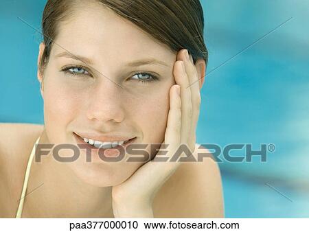 Woman resting head on hand, smiling, portrait View Large Photo Image Stock Image - Woman resting head on hand, smiling, portrait. Fotosearch