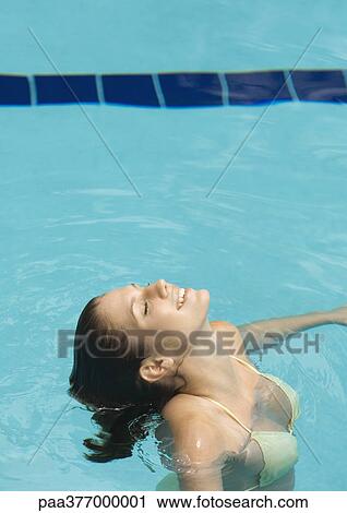 Woman standing in pool with head back and eyes closed View Large Photo Image Stock Image - Woman standing in pool with head back and eyes closed. Fotosearch