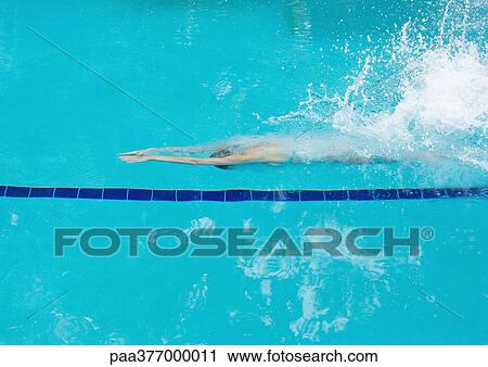 Woman under water after diving into pool View Large Photo Image Stock Image - Woman under water after diving into pool. Fotosearch