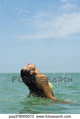 Woman emerging from sea, water spraying in air View Large Photo Image Stock Image - Woman emerging from sea, water spraying in air. Fotosearch