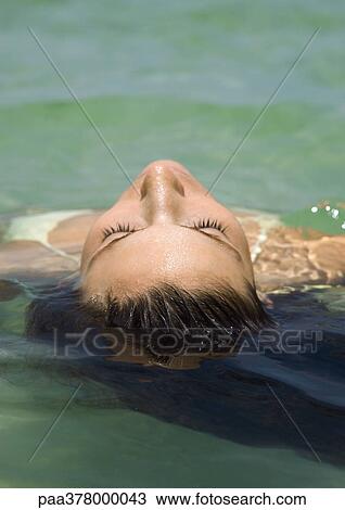 Woman floating in water View Large Photo Image Stock Image - Woman floating in water. Fotosearch