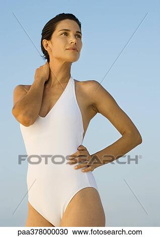 Woman in swimsuit standing, looking away View Large Photo Image Stock Image - Woman in swimsuit standing, looking away. Fotosearch