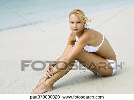 Woman sitting on beach, full length View Large Photo Image Stock Image - Woman sitting on beach, full length. Fotosearch