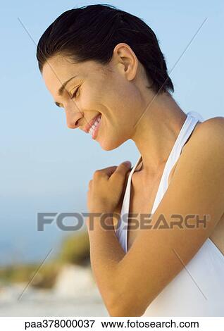 Woman smiling, looking down View Large Photo Image Stock Photo - Woman smiling, looking down. Fotosearch