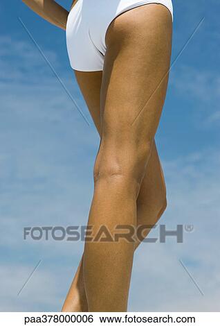 Woman standing in sun, close-up of legs View Large Photo Image Stock Photograph - Woman standing in sun, close-up of legs. Fotosearch